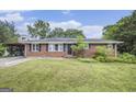 Charming single-story brick home featuring a well-maintained lawn and a cozy, inviting facade at 734 Meadowlark Dr, Villa Rica, GA 30180