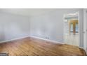 Spacious living room with hardwood floors, neutral walls, and a seamless transition to adjacent rooms at 734 Meadowlark Dr, Villa Rica, GA 30180