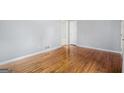 Bright living room featuring gleaming hardwood floors, fresh paint, and easy access to other rooms at 734 Meadowlark Dr, Villa Rica, GA 30180