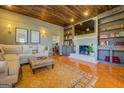 Inviting living space featuring a fireplace, built-in shelving, and wood ceiling at 5143 Floyd Ne St, Covington, GA 30014