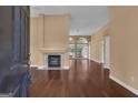 Open concept living room with a fireplace and large windows for ample natural light at 111 Kenton Pl, Peachtree City, GA 30269