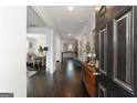 Elegant foyer featuring dark hardwood floors and views of the dining room and kitchen, offering a seamless flow at 3692 Wartrace Dr, South Fulton, GA 30331
