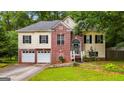 Inviting home exterior showcasing a brick-accented facade, double garage, and well-maintained landscaping at 129 Onyx Ct, Carrollton, GA 30116