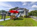Quaint home with a cozy front porch, complemented by a picnic table and red umbrella at 1091 Selwin Sw Ave, Atlanta, GA 30310