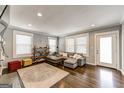 Inviting living room with a comfortable sectional sofa, hardwood floors, and ample natural light at 1091 Selwin Sw Ave, Atlanta, GA 30310