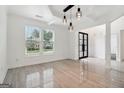 Elegant dining room with stylish lighting, tiled floors, and views of the landscaped yard at 4186 Matisse Ln, Fairburn, GA 30213