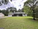Traditional home with large yard, attached garage, and classic curb appeal at 150 Willow Shoals Dr, Covington, GA 30016