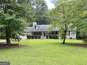 Welcoming one-story home with dormer windows and spacious front yard at 150 Willow Shoals Dr, Covington, GA 30016