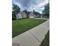 A charming single-Gathering home with a well-manicured lawn and a spacious driveway at 1925 Cedar Walk Ln, Conley, GA 30288