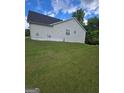 Exterior view of house with green grass yard at 1925 Cedar Walk Ln, Conley, GA 30288