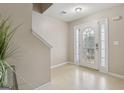 Bright foyer featuring a front door with glass panels, neutral walls, and tiled flooring, offering a welcoming entrance at 7813 Newbury Dr, Jonesboro, GA 30236