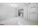 Bright living room featuring porcelain tile floors, large window, and modern finishes at 984 Wenham Ln, Lawrenceville, GA 30044