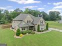 Attractive two-story house with mature trees, a large yard, and an extended driveway at 108 Donovan Ave, Locust Grove, GA 30248