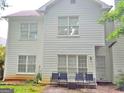 The backyard exterior features a white siding and windows, along with outdoor seating at 3332 Glenrose Trl, Chamblee, GA 30341