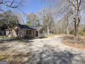 Quaint home on a large lot with a long gravel driveway and fenced yard at 927 Dean Patrick Rd, Locust Grove, GA 30248