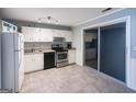 Bright kitchen featuring white cabinets, stainless steel appliances, and sliding glass doors leading to a porch at 796 Glynn Oaks Dr, Clarkston, GA 30021
