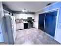 Functional kitchen featuring white cabinets, stainless steel appliances, and a sliding glass door at 796 Glynn Oaks Dr, Clarkston, GA 30021