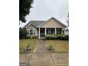 Inviting single-story home with classic facade, pillars, and landscaped front yard at 300 Monarch Village Way, Stockbridge, GA 30281