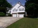 Charming two-story home featuring a 2-car garage, stone accents, and a well-maintained lawn at 49 Brinkley Ct, Dallas, GA 30157