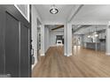 Open-concept living space featuring light wood floors, neutral walls, and views of kitchen and backyard at 296 Deer Creek Run # 11, Moreland, GA 30259