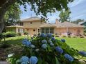 Expansive backyard with mature trees, patio furniture, and an enclosed sunroom at 404 Windsor Way, Peachtree City, GA 30269
