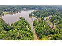 Scenic aerial view of the community's waterfront property surrounded by lush greenery and serene waters at 610 Lake Dr, Snellville, GA 30039