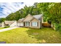 Landscaped front yard of a cozy home featuring a two-car garage and charming curb appeal at 345 Morning Star Dr, Temple, GA 30179