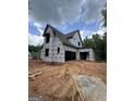 New home under construction featuring an attached garage, multiple windows and a spacious lot at 385 Snead Rd, Fayetteville, GA 30215