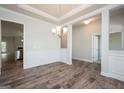 Spacious dining area with hardwood floors, decorative wainscoting, and elegant lighting at 267 Eason St, Bowdon, GA 30108