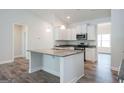 Modern kitchen with granite countertops, stainless steel appliances, and a center island at 267 Eason St, Bowdon, GA 30108