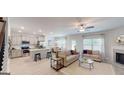 Open-concept living room featuring a fireplace, modern furnishings, and ample natural light at 263 Eason St, Bowdon, GA 30108