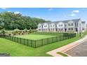 Community dog park surrounded by a black fence and lush green grass at 1402 Grand Branch Dr, Lawrenceville, GA 30045