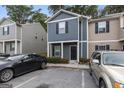 Two-story townhouse featuring a dark gray facade, black door, and adjacent parking at 2137 Chadwick Sw Rd, Atlanta, GA 30331