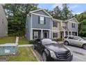 Townhouse exterior featuring dark gray facade and front parking at 2137 Chadwick Sw Rd, Atlanta, GA 30331