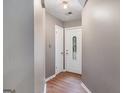 Entryway with wood-look floors and a decorative glass front door at 113 Caldwell Dr, Hampton, GA 30228