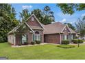 Angle shot showcasing the home's brick exterior and landscaped yard at 2928 Mandy Ct, Jonesboro, GA 30236