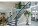 Elegant foyer with a curved staircase, wrought iron railings, and marble flooring with decor at 413 Canterbury Way, Jonesboro, GA 30236