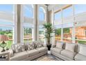 Bright living room featuring floor-to-ceiling windows, neutral tones, and comfortable seating at 413 Canterbury Way, Jonesboro, GA 30236