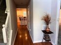 Inviting foyer with hardwood floors, staircase, decorative console table and view to the kitchen at 149 Titan Rd, Stockbridge, GA 30281
