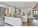 Open kitchen featuring white cabinetry, stainless steel appliances, and a large island with bar seating at 2975 Hickory Hill Rd, Brooks, GA 30205
