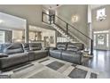 Living room with hardwood floors, neutral paint, and a staircase with a modern railing design at 2975 Hickory Hill Rd, Brooks, GA 30205