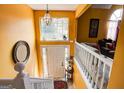 Inviting foyer featuring a staircase, large window, and bright yellow walls creating a warm and welcoming atmosphere at 7101 Brecken Pl, Lithonia, GA 30058