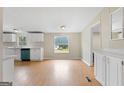 Cozy dining area with views of the yard, bright lighting, and wood flooring creating a warm space at 368 Hemlock Ln, Locust Grove, GA 30248