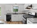 Modern kitchen features white cabinets, granite countertops, and stainless steel appliances at 1432 Almand Creek Drive Sw, Conyers, GA 30094