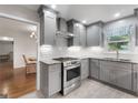 Updated kitchen featuring stainless steel appliances, stylish gray cabinets and hardwood floors at 7972 Woods Lane, Jonesboro, GA 30236