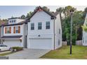 Charming two-story home showcasing white siding, a two-car garage, and a well-maintained lawn at 375 Auburn Valley Way, Auburn, GA 30011