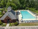 Aerial view of community clubhouse with a pool, surrounded by lounge chairs and landscaped grounds at 330 Bay Grove Rd, Loganville, GA 30052