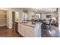 Modern kitchen with a large island, granite countertops, and stainless steel appliances that overlooks the living area at 2276 Waycross Ln # 21, Dacula, GA 30019