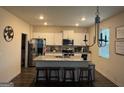 Bright kitchen featuring white cabinets, a granite island with seating, and stainless steel appliances at 2276 Waycross Ln # 21, Dacula, GA 30019