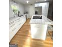 Well-lit kitchen showcases marble countertops, stainless steel appliances, and a central island at 242 Adair St, Decatur, GA 30030